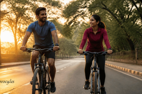 Two riders on rented geared bicycles cycling on a tree-lined road in Pune at sunrise